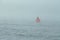 A marker buoy floating in the sea. beacon.