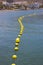 Marker Buoys to prevent bathers entering an area next to the pier used by boats and small craft in the bay at Los Cristianos in Te