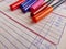 Markers for drawing lie on the diary. Paper diary of a second grade student. Primary school. Retro. Closeup.