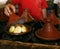 Market cook holding a cover of a tajine, Morocco