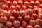 Market counter with whole ripe unpeeled pomegranates