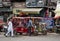 market and electric rickshaw taxis on the street. landscape of an ordinary Indian city.