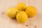 Market fresh organic : four lemons on a wooden table