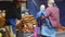 Market stall owner serving a customer and her very young child at a bread stall outside King`s Cross Railway Station