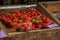 Market, trade in fresh products. Wooden box with strawberries sorted by trays.