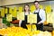 Market workers with citrus fruits