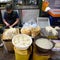 Marketeer prepares tofu and germination in street market of Hong Kong