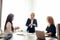 Marketing experts sit around table and looking at woman speaker at meeting.