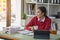 Marketing, Finance, Accounting, Planning, A female accountant holds a coffee cup and uses a laptop computer and documents, charts