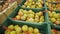 Marketplace.In the foreground beautiful colorful apples on the stall. Big apples in wooden boxes on the stand.