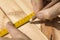 Marking distances. The carpenter`s hands measure distance measure.