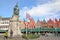 The Markt with colorful facades and statues of Jan Breydel and Pieter de Coninck in the foreground