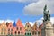 The Markt with colorful facades and statues of Jan Breydel and Pieter de Coninck in the foreground