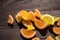 Marmalade lemon slices scattered on a wooden table in the sunlight, close-up, selective focus.