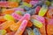 Marmalade multicolored worms, sweets, harmful food. Background.