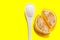 Marmalade pieces of sticky candy on a yellow background. A spoonful of sugar and slices of marmalade