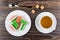 Marmalade in plate, sugar cubes, tea in cup and teaspoon