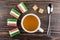 Marmalade, sugar cubes, tea in cup and teaspoon on table