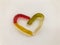 Marmalade worms. gelatinous worms, multi-colored intertwined in the shape of a heart. bright and tasty gelatinous high-calorie