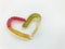 Marmalade worms. gelatinous worms, multi-colored intertwined in the shape of a heart. yellow-red and green-white worm on a white