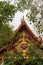 Maroon gable with golden decoration of scary face on Ko Samui Island, Thailand