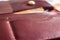 Maroon leather wallet pockets closeup - Image