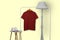 Maroon polo shirt hanging on rack isolated on plain background