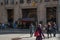 Marquee at Rockefeller Center with a sign for The Tonight Show starring Jimmy Fallon with people walking by on the sidewalk and