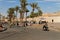 Marrakech, Marocco Okt,7,2018,Street market on sidewalk, blue sky with old city wall and palm trees. People try to sell
