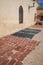 Marrakech, Morocco - Feb 10, 2023: Tanned leather pieces drying in the sun on a street in the Medina of Marrakech