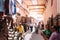 Marrakech, Morocco, september 16, 2019: oriental market with people walking and riding their motorbikes through the narrow street