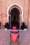 Marrakesh, Morocco - March 13, 2018: A man in a wheelchair waits at the entrance of the Koutoubia Mosque for someone to help him