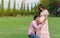 Married couple is expecting a baby. man kissing belly of his pregnant wife in park