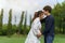 Married couple is expecting a baby. man kissing his pregnant wife in park