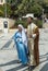 A married couple - husband and pregnant wife in the clothes of Jesus` time - stand in front of the Basilica of the Annunciation in