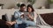 Married couple relaxing on sofa using tablet device