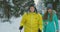 A married couple is skiing in the forest practicing a healthy lifestyle. Slow motion