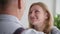 married couple, smiling woman lovingly looks at her husband and hugs him tightly, close-up