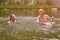 Married couple swimming in the river during vacation