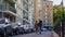 Married couple walking together at modern city residential complex rear view.