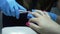 A married woman takes her nail off her nails
