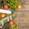 marrow squash, measure tape, bottle of water, flowers, tomatoes and cucumbers on brown wooden table