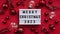 Marry Christmas banner concept. White board with the text Marry Christmas 2023 among Christmas red decor, balls and berries on a