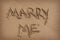 \'Marry Me\' Written in Sand on Beach