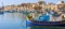 Marsaxlokk fishermen village in Malta. Traditional colorful boats at the port of Marsaxlokk