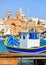 Marsaxlokk fishermen village in Malta. Traditional colorful boats at the port of Marsaxlokk. Closeup view