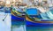 Marsaxlokk fishermen village in Malta. Traditional colorful boats at the port of Marsaxlokk. Closeup view