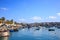 Marsaxlokk historic port full of wooden boats in Malta. Blue sky and village background.