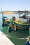 Marsaxlokk, Malta, August 2019. Steering devices at the stern of colorful fishing boats.