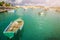 Marsaxlokk, Malta - Traditional colorful maltese Luzzu fisherboats at the old market of Marsaxlokk with green sea water